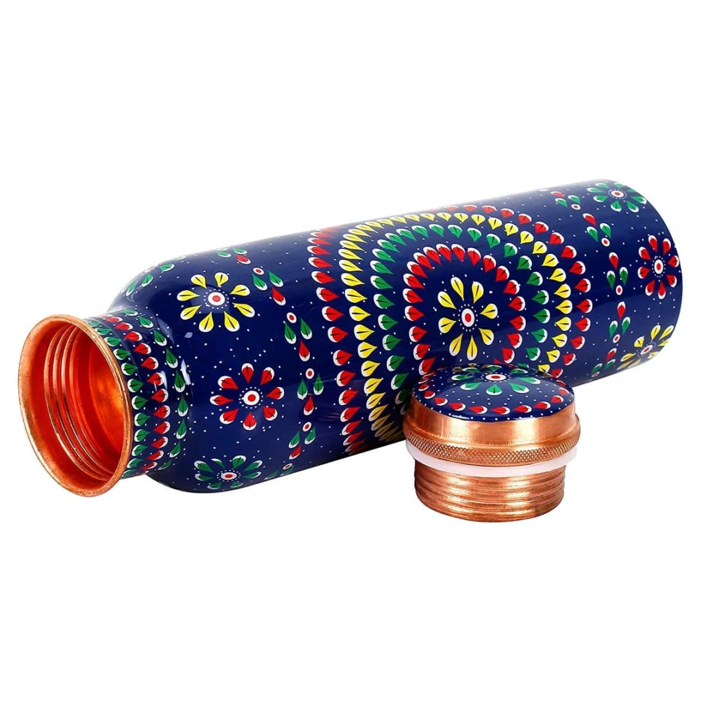 Our enamel print pure copper water bottles combine traditional craftsmanship with a modern, eye-catching design. Handmade by skilled artisans in India, each bottle is crafted from high-quality 100% pure copper, ensuring durability and health benefits. These bottles are perfect for everyday hydration, supporting a balanced lifestyle while making an eco-friendly choice. According to Ayurveda, storing water in a copper vessel helps balance the body's three doshas, resulting in naturally alkaline water that promotes better pH balance. The ergonomic design, along with a wide-mouth opening, ensures ease of use. These bottles are not just functional but a work of art. Perfect for your fitness routine, outdoor adventures, or simply adding a stylish element to your daily hydration.