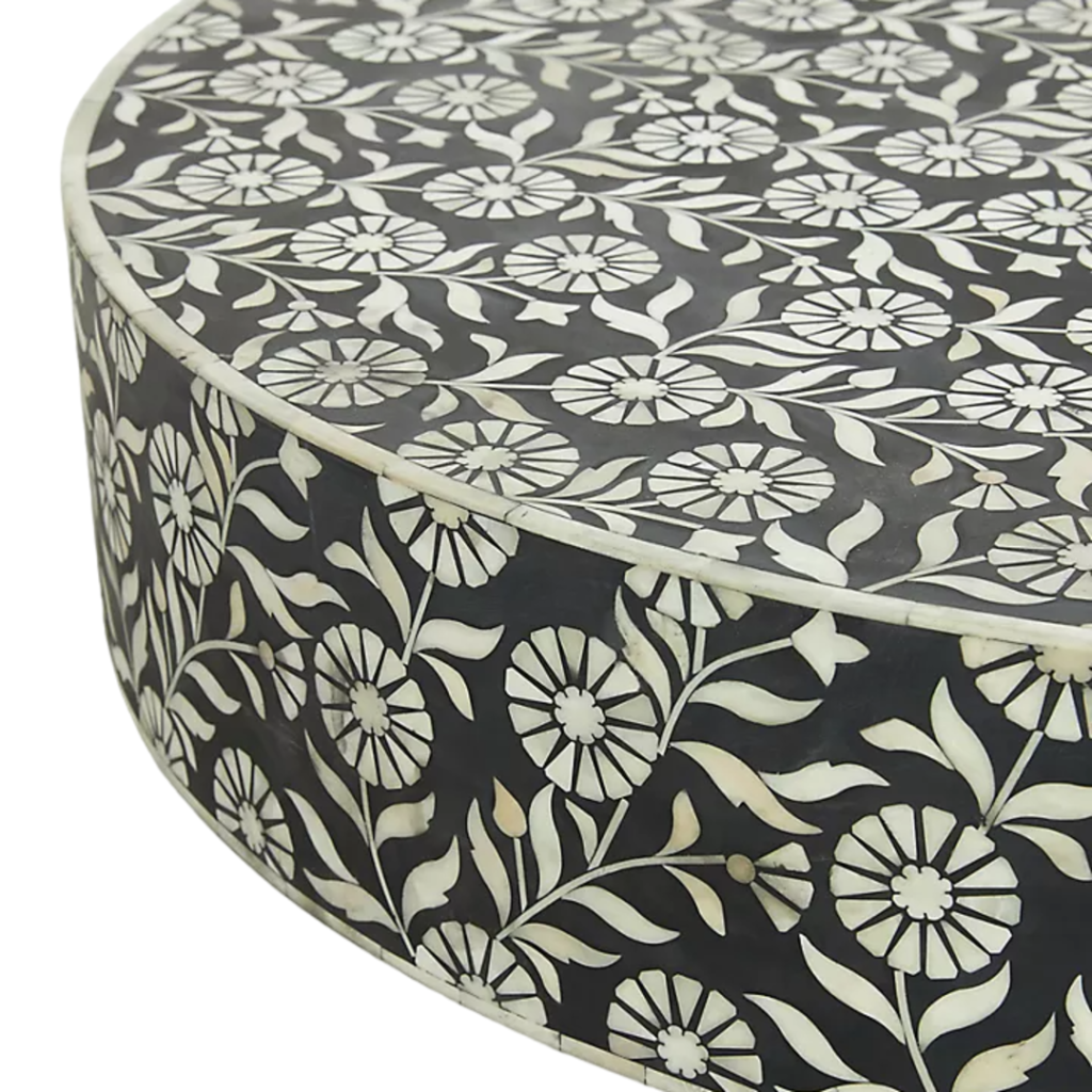 Elevate your living space with this stunning bone inlay coffee table, meticulously handcrafted by skilled artisans. Featuring a beautiful black and white floral pattern with a striking striped pedestal base, this unique piece is both functional and artistic. Made from tropical hardwood with intricate bone and resin inlay, this coffee table is sealed with a clear lacquer, ensuring durability and longevity. Its 36-inch diameter and elegant design make it a perfect centerpiece for any living room, offering a luxurious touch to both modern and traditional interiors.