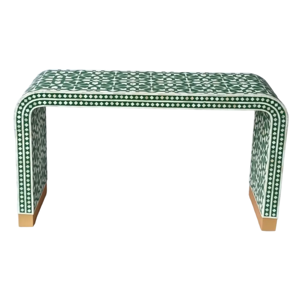 Bring a touch of elegance and craftsmanship to your living space with this exquisite Bone Inlay Console Table. Handcrafted by skilled artisans, this piece features intricate hand-carved bone details and curvaceous corners that create a sophisticated and timeless design. The console is made from solid wood and MDF for durability and longevity. Its base is accentuated with a brass cladding, offering a luxurious touch while enhancing the overall aesthetics. With its sleek and modern form, this console table is perfect for your entryway, living room, or hallway, adding both beauty and functionality to any space