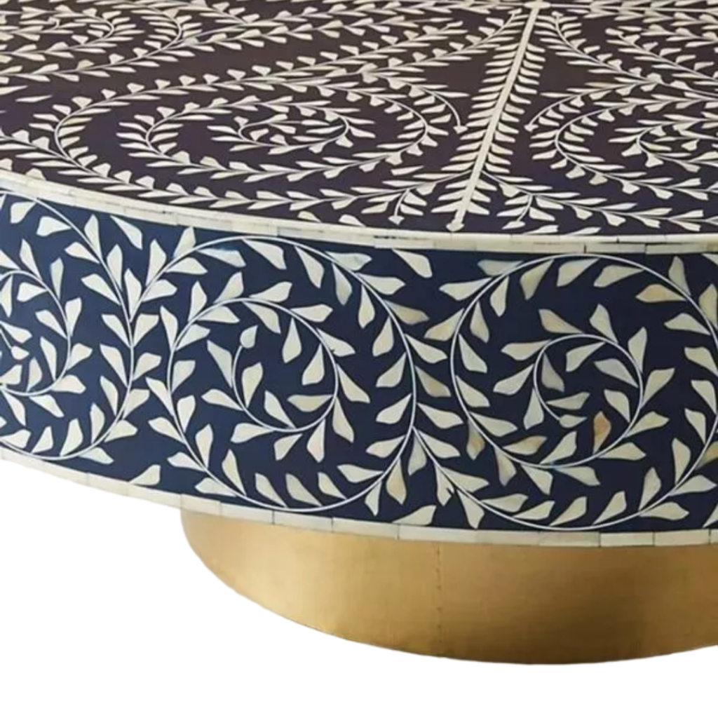 Add a touch of elegance and artistry to your living spaces with this Handmade Bone Inlay Round Coffee Table, crafted with precision by skilled artisans. This stunning piece combines intricate floral bone inlay patterns with a smooth brass base, creating a luxurious and eye-catching centerpiece. Its large round design provides ample space for serving or decorating, making it perfect for entertaining or showcasing your favorite items. Made from high-quality wood, resin, bone, and metal, this table not only stands out as a statement piece but also adds a refined charm to any modern or traditional décor.
